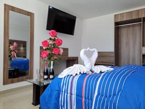 a bedroom with a bed with a swan on it at Hoteles Gutiérrez Mansión in Arequipa