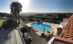 a view of a swimming pool from a house at Casa o Futuro in Alcobaça