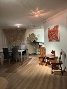 uma sala de jantar com uma mesa e cadeiras e uma lareira em CA' del GIACOMINO em Baselga di Pinè