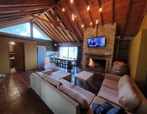 a living room with a couch and a fireplace at El Remanso in Villa Residencial Laguna Brava