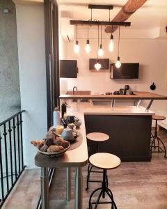 a kitchen with a table and some chairs and tables at L'essens in Fayence