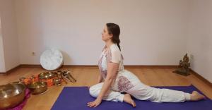 a woman sitting on a yoga mat in a room at HOTEL YOGA JASMIN ehemals Hotel Eberhardt-Burghardt in Badenweiler