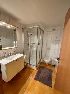 a bathroom with a shower and a sink and a toilet at V&A Home 