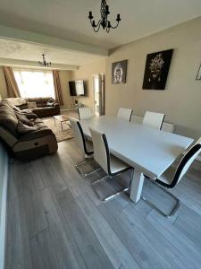 a living room with a white table and chairs at Gants hill in Barkingside