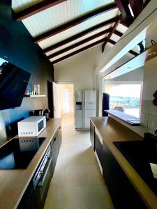a kitchen with a counter top with a refrigerator at Villa Zenith in Case-Pilote