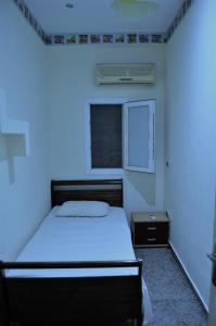 een slaapkamer met een bed en een blauw licht bij Sharm El Sheikh flat 2 bedrooms in front of pool in Sharm El Sheikh