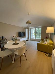 a living room with a table and a couch at Pergolato junior in Sanremo