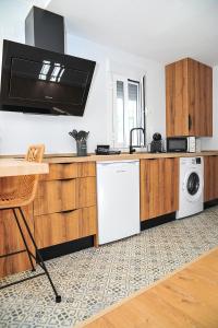 埃爾博斯克的住宿－Mardelunas，厨房配有洗衣机、烘干机和微波炉
