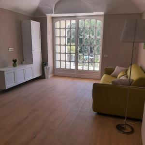 a living room with a couch and a large window at Pergolato junior in Sanremo +35 photos