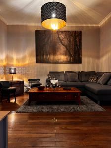 a living room with a couch and a coffee table at la Porte aux Dames in Romorantin