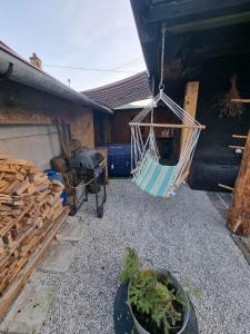 una hamaca colgada de una casa con patio en Drevenica na Považí, en Dolná Mariková