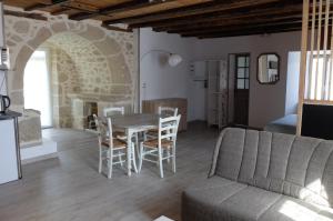 a living room with a table and chairs and a couch at Le Cosy in Sousceyrac