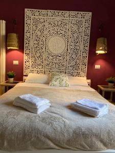 a bedroom with a large bed with two towels on it at Le Tre Terrazze in Bologna
