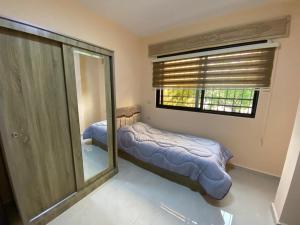 a bedroom with two beds and a mirror at Moon Apartments in Jerash