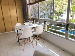 a table and chairs in a room with windows at Apto. 2 dorm. Marbella 100m playa in Marbella