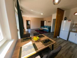 a kitchen and dining room with a table with bananas on it at Apartman KOSTA in Trebinje