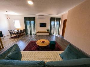 a living room with a couch and a table at Apartman KOSTA in Trebinje