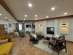 a living room with couches and chairs and a fireplace at 4US RIOJA WINE HOTEL in Cenicero