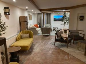 a living room with couches and chairs at 4US RIOJA WINE HOTEL in Cenicero