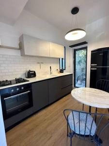 a kitchen with a table and a counter top at Central Studio with a Garden in Tel Aviv