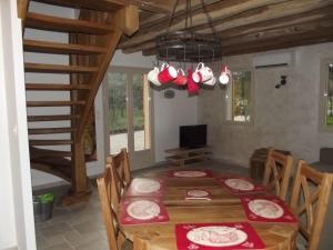 a dining room with a wooden table and chairs at La Haute Bédinière in Crouy-sur-Cosson