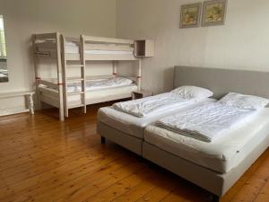 a bedroom with two bunk beds and a wooden floor at Jagdschloss Siedlinghausen EG in Winterberg