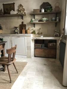 a kitchen with a table and a chair in a room at Borgo Ferracina by BORGHI VENETI in Solagna