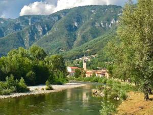 a view of a river with mountains in the background at Borgo Ferracina by BORGHI VENETI in Solagna
