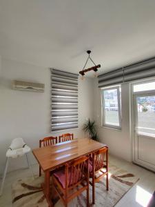 a dining room with a wooden table and chairs at The Life House Alanya in Alanya