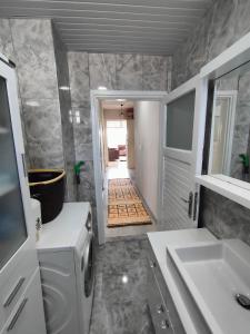 a bathroom with a sink and a microwave at The Life House Alanya in Alanya