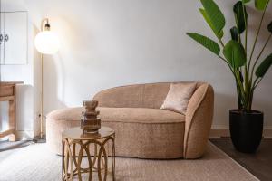 a living room with a chair and a table at Court Hotel Utrecht City Centre in Utrecht