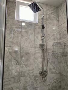 a shower with a glass door in a bathroom at The Life House Alanya in Alanya
