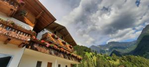 a building with balconies with a view of mountains at Pixnerhof Urlaub auf dem Bauernhof in Schenna