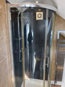 a shower with a glass door in a bathroom at Large, Quiet, Sleeps 16, 4 bathrooms, Parking, Leicester in Leicester +41 photos