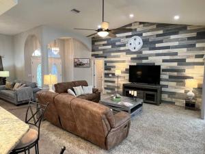 a living room with a couch and a tv at Peachland getaway with heated pool and tiki bar in Port Charlotte