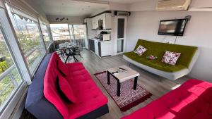 a living room with two couches and a table at Can’s Homes in Kuşadası