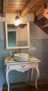 a bathroom with a sink and a mirror at EL VIEJO MOLINO in Lugo