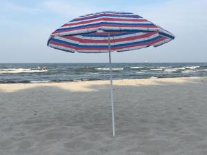 una sombrilla en la arena de la playa en Super-Ostseeferien, en Graal-Müritz