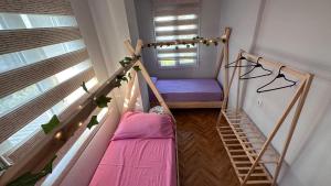 a small room with a bunk bed and a window at Can’s Homes in Kusadası