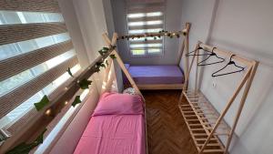 a small room with a bunk bed and a window at Can’s Homes in Kuşadası