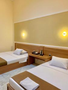 Postel nebo postele na pokoji v ubytování Al-Kiswah Syariah Guest House