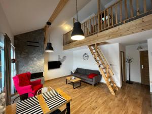 a living room with a loft with a staircase at Wellness & View Skrzyczne, Sauna, Jacuzzi - w cenie in Szczyrk