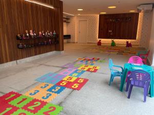 a room with a table and chairs on the floor at Salinas Exclusive Resort in Salinópolis
