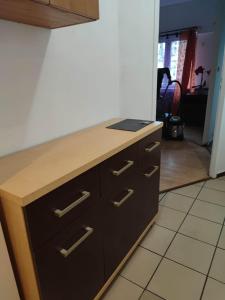 a kitchen with a wooden counter top withdrawers at Pokoje pracownicze Witkowska in Gniezno