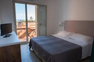 Cama ou camas em um quarto em Hotel Villino Gallodoro