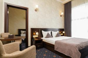a hotel room with a bed and a table and chairs at Amberd Hotel in Byurakan +96 photos