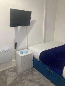 a small bedroom with a bed and a night stand at The New Apollo Hotel in Blackpool