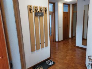 a hallway with a mirror and shoes on the floor at Apartma David in Most na Soči