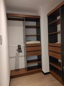 a room with a closet with wooden shelves at Hermoso apartamento nuevo en zona 10! in Guatemala