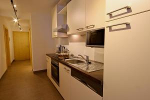 a kitchen with a sink and a counter top at Alexandra's Apartment in Neustift im Stubaital